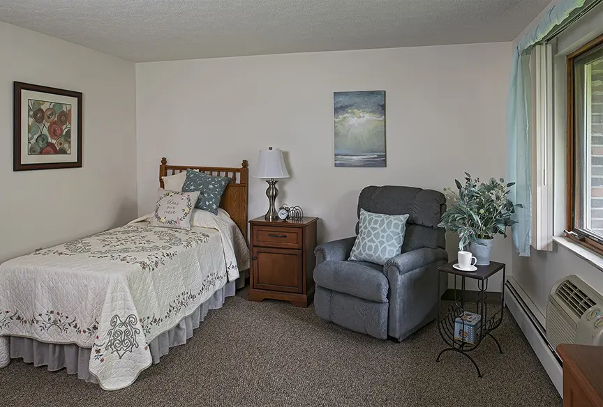 Bedroom at American House Kentwood, a memory care and assisted living facility adsf